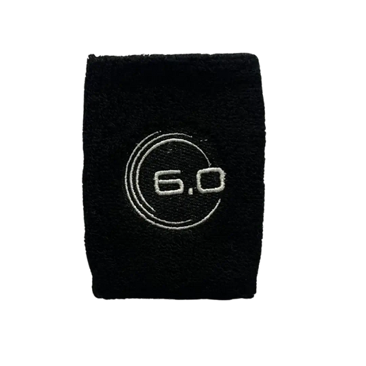 Six Zero black sweat wrist band featuring embroidered logo, made from lightweight dry-fit cotton for moisture management.