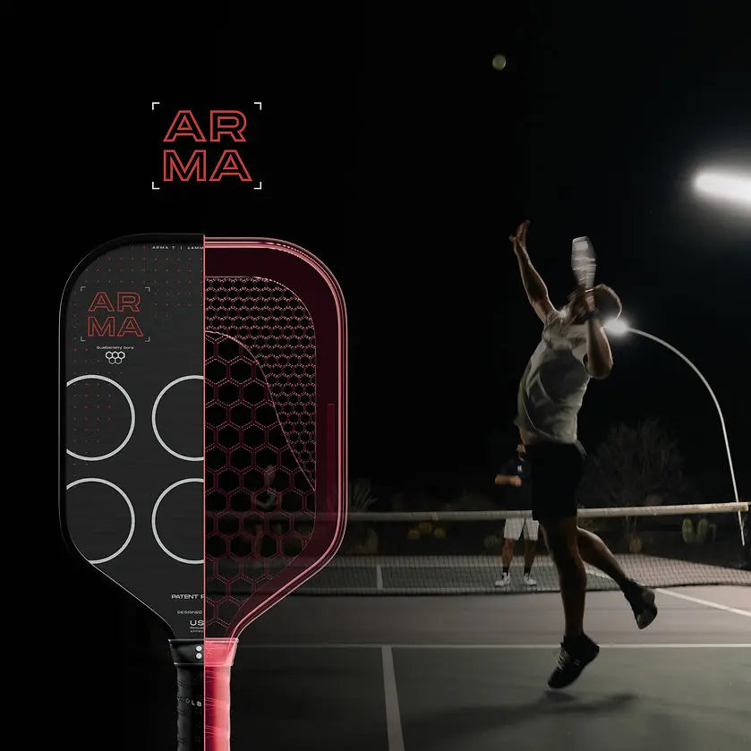 ARMA paddle in metallic design with player serving in a dimly lit tennis court at night.