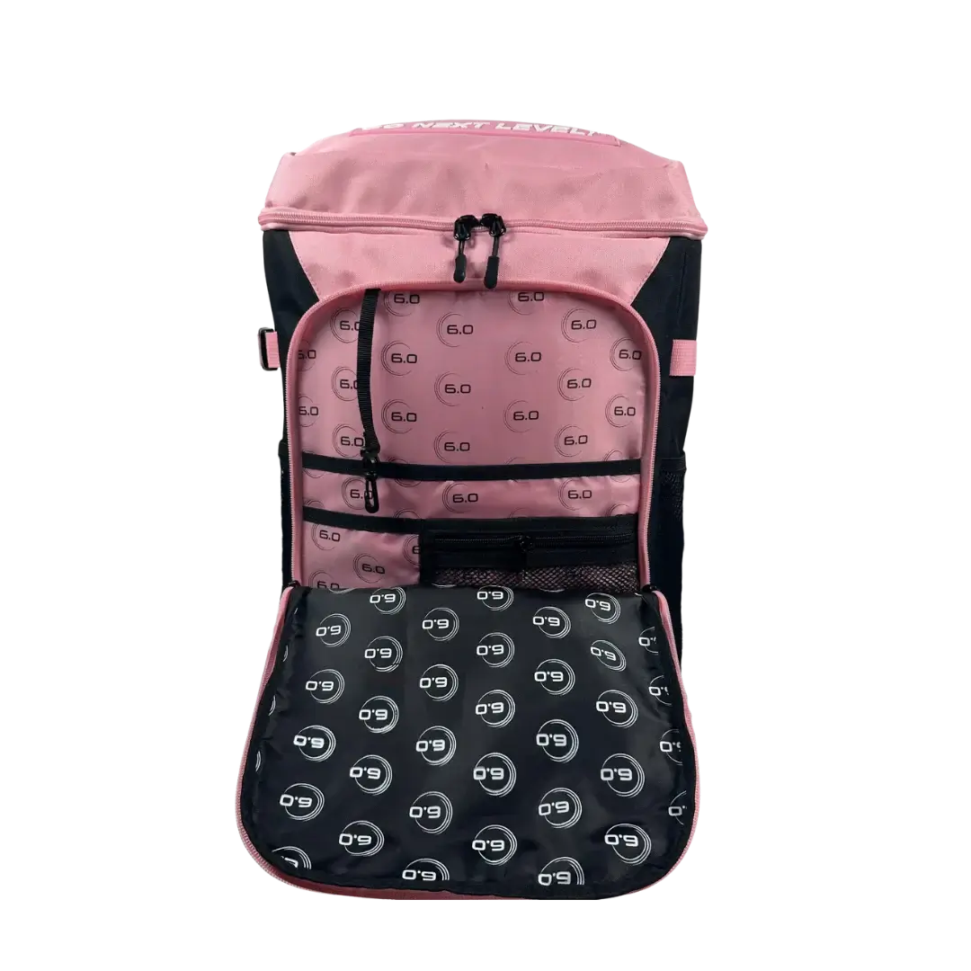 Inside view of Six Zero Performance Backpack featuring pink lining and logo pattern, designed for pickleball and travel.