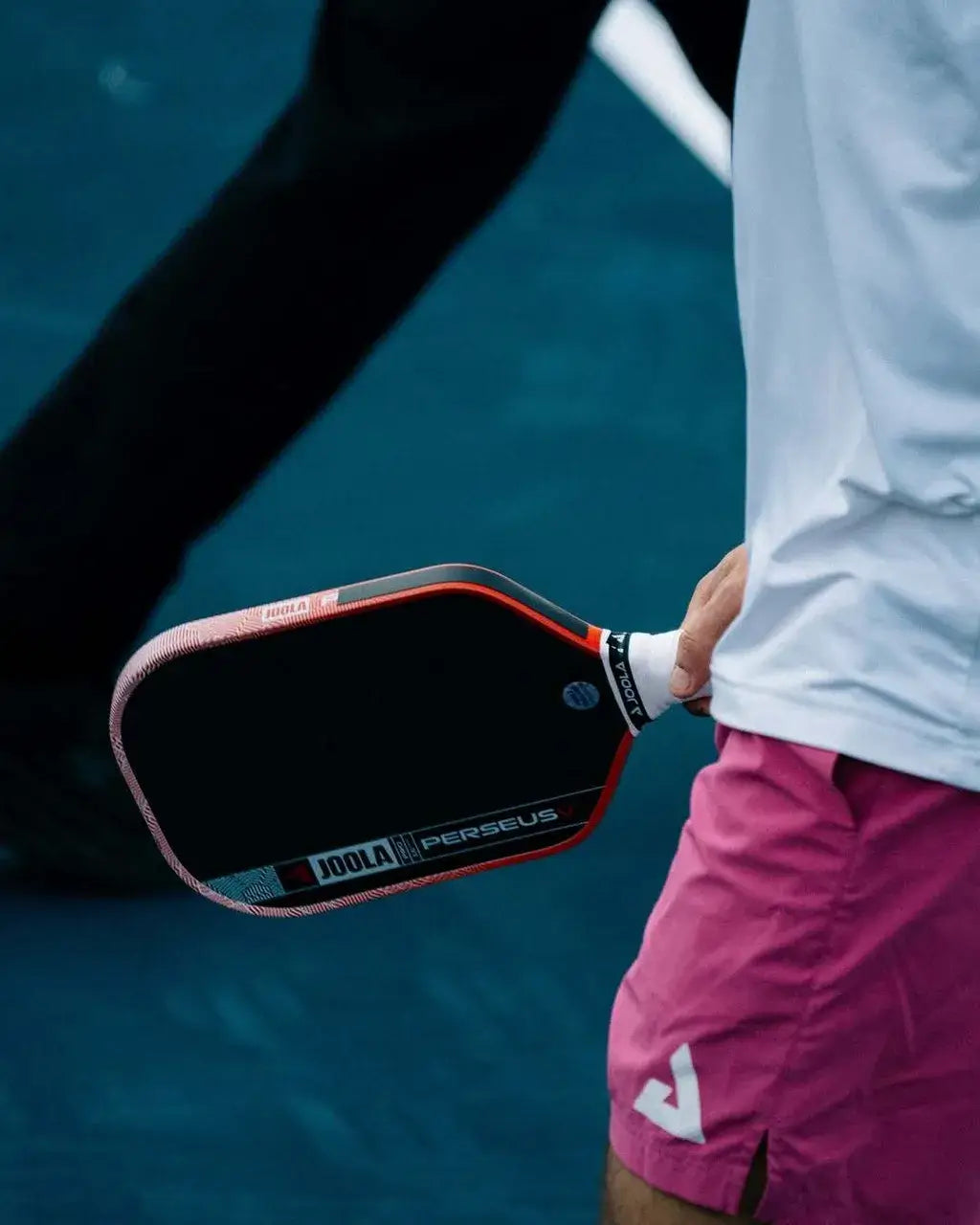 Joola Perseus Pro V Ben Johns Blaze Red (Global) held by a player on the court preparing to play.