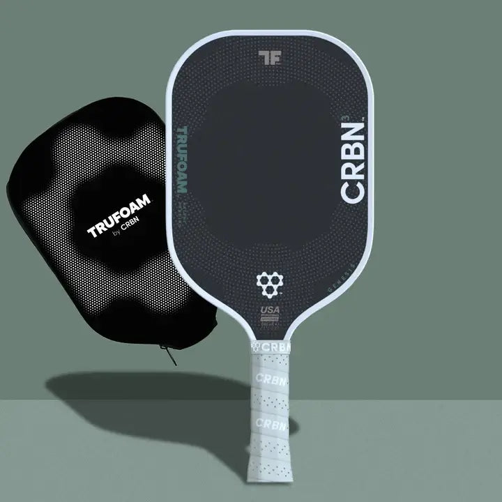 CRBN TruFoam™ Genesis paddle and protective cover on a green background, showcasing advanced pickleball technology.