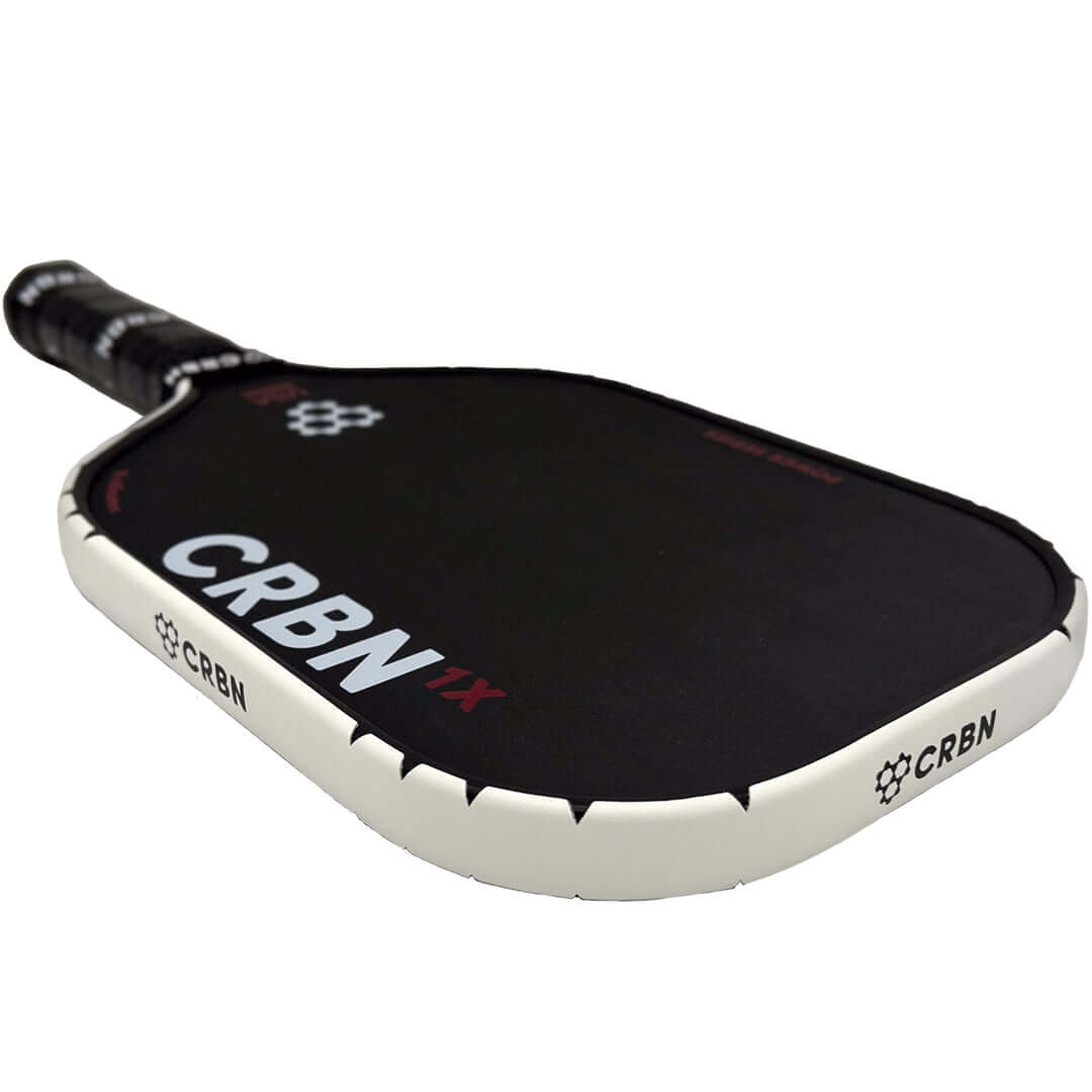 CRBN paddle with white protective edge guard tape showcasing seamless sawtooth corner design and CRBN branding.