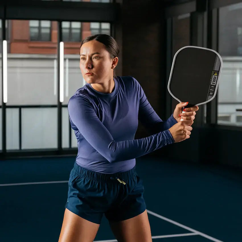 Athlete showcasing JOOLA Anna Bright Scorpeus Pro IV pickleball paddle in a dynamic indoor setting.