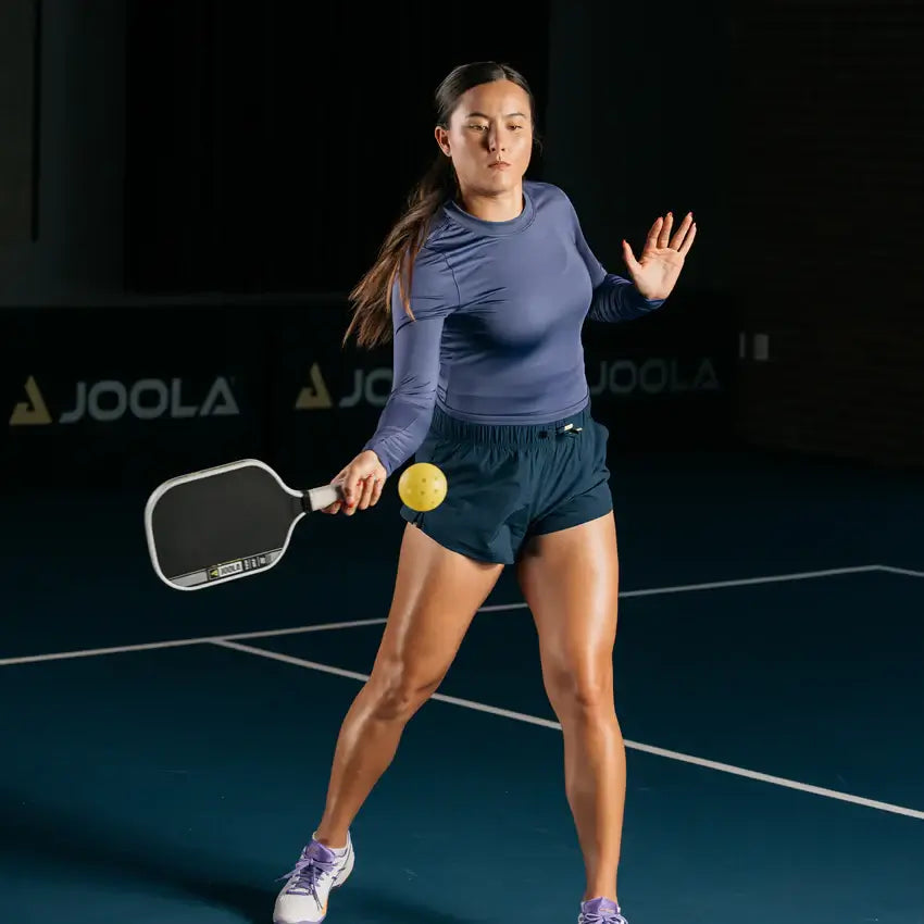 Player demonstrating JOOLA Anna Bright Scorpeus Pro IV pickleball paddle on court during a match.