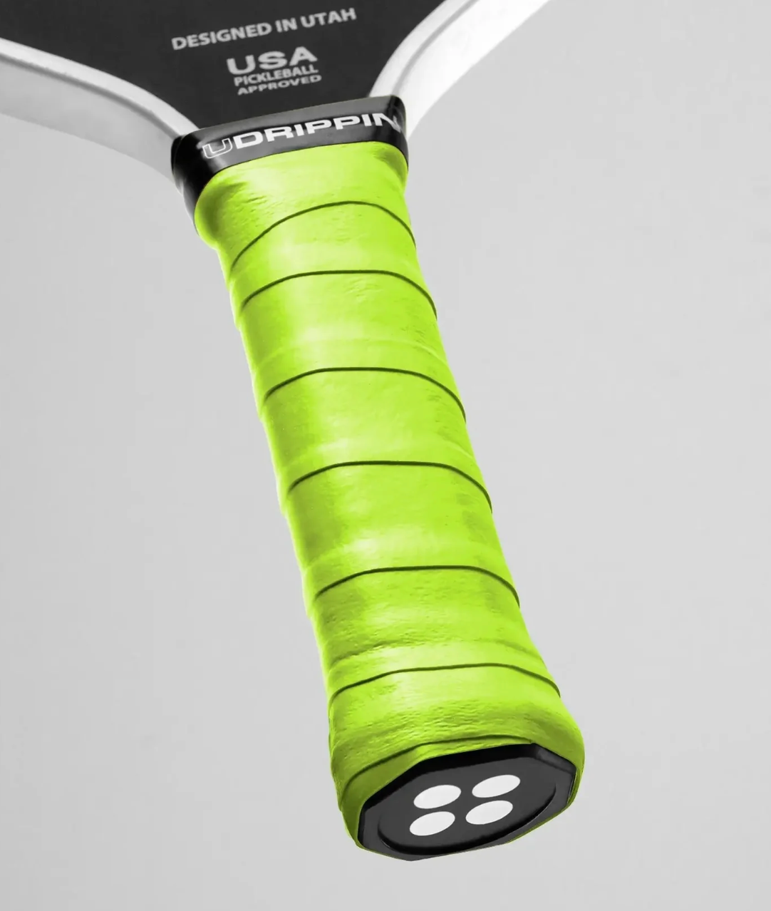 Close-up of Udrippin Pro Dry Grip on pickleball paddle, showcasing premium wet absorbing material and 0.58mm thickness.