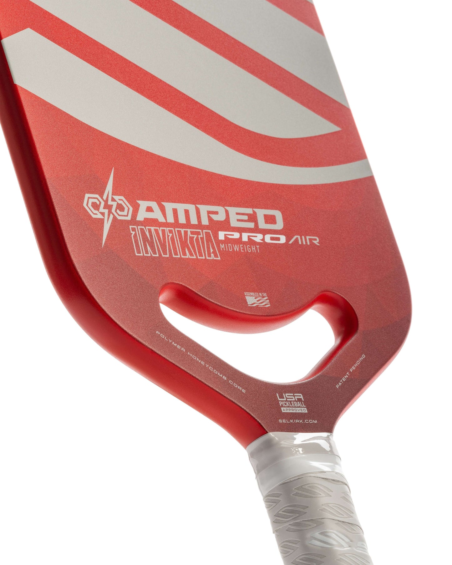 Selkirk AMPED Pro Air Invikta pickleball paddle showcasing ergonomic handle and vibrant red design.