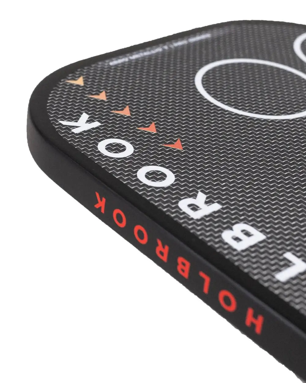 Holbrook Pro Aero Metallic T pickleball paddle close-up showing grip and design details.