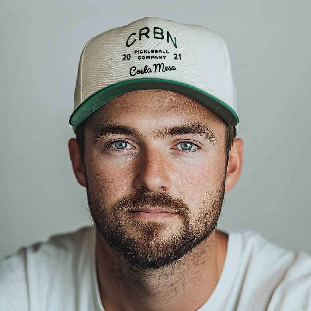 Man wearing a CRBN Heritage Snapback hat with classic pickleball design and vintage charm.