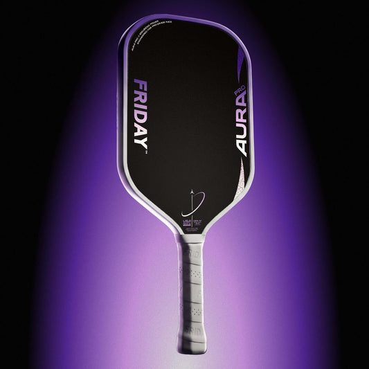 Friday AURA PRO - Elongated paddle showcasing its enhanced design and features in a dramatic lighting.
