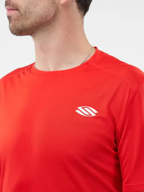 Close-up of a man wearing a red short sleeve performance tee, ideal for sports and active wear.