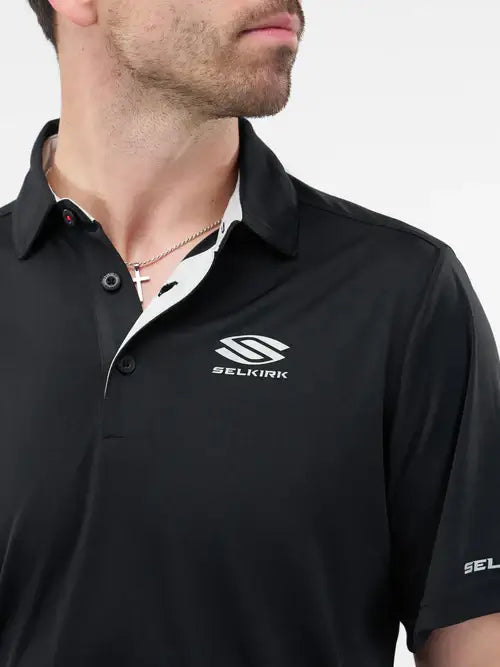Men’s Essentials Sport-Wik Short Sleeve Polo in black, featuring the Selkirk logo and a relaxed fit for active wear.