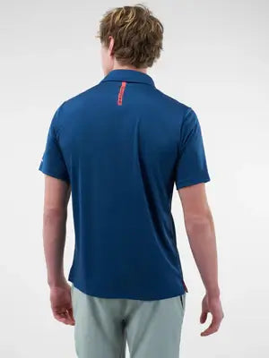 Back view of a man wearing a blue Men’s Essentials Sport-Wik Short Sleeve Polo with a stylish collar.