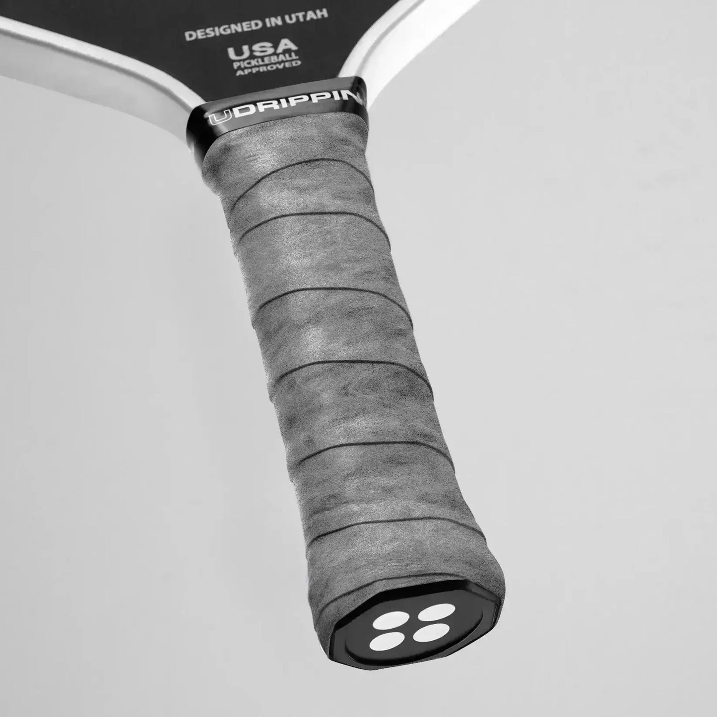 Close-up of Udrippin Pro Dry Grip on pickleball paddle, showcasing premium wet absorbing material and 0.58mm thickness.
