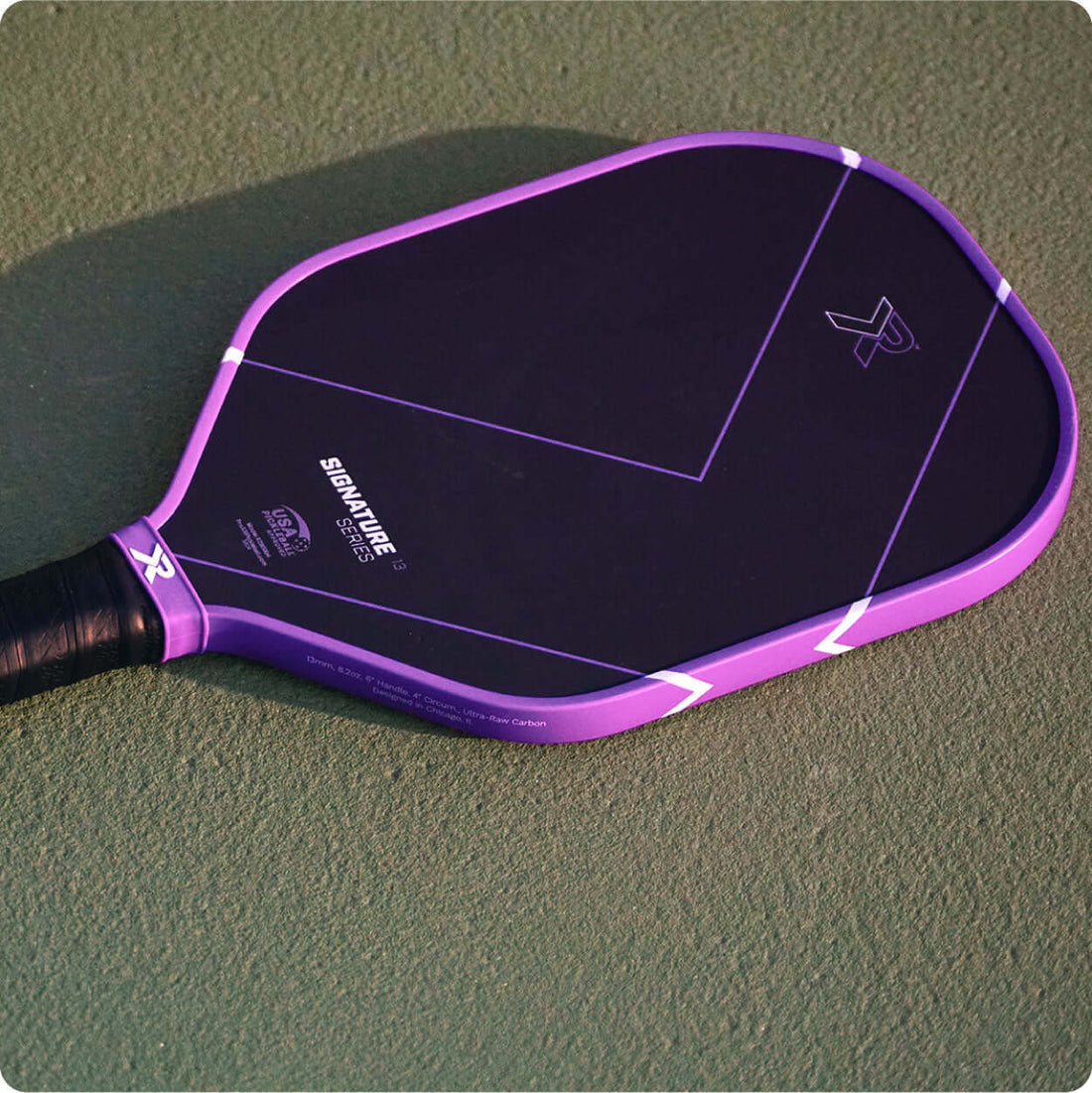 Premium pickleball paddle resting on an outdoor court, illustrating the 2026 shift toward foam-core paddles
