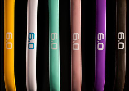 Six Zero Quartz Pickleball Paddles in various colors including yellow, white, teal, pink, purple, and black displayed upright