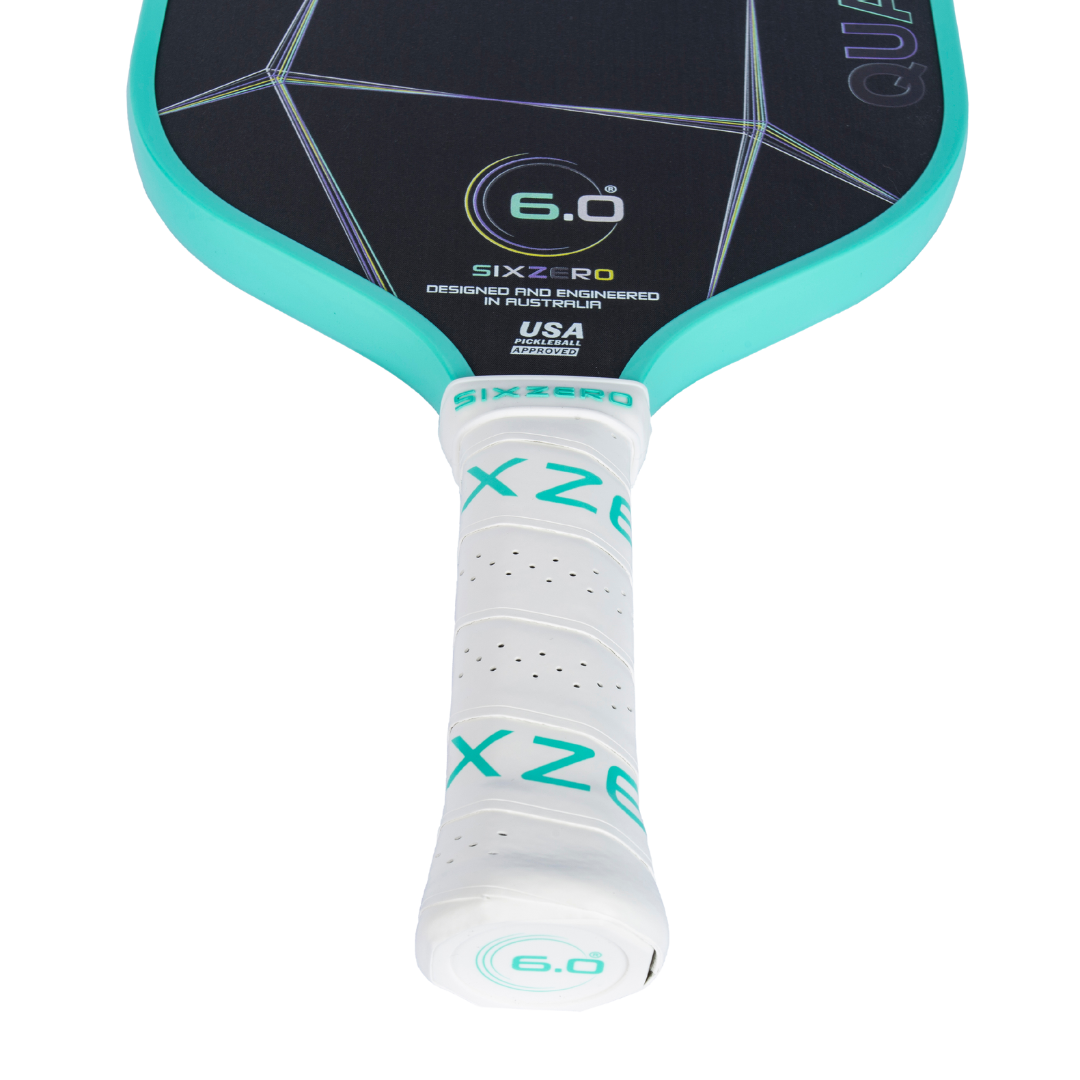 Six Zero Quartz Pickleball Paddle with teal edges and white handle, designed for quality performance at an affordable price