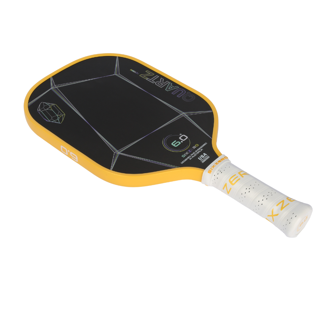 Six Zero Quartz pickleball paddle with large black surface, yellow edges, and white grip, ideal for quality performance and affordability.