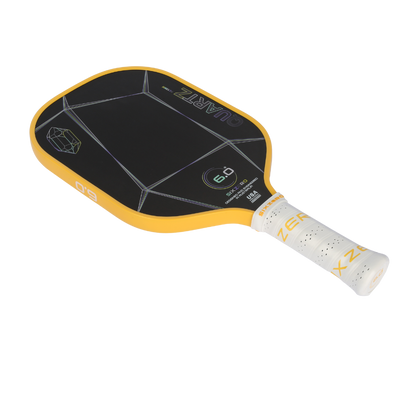 Six Zero Quartz pickleball paddle with large black surface, yellow edges, and white grip, ideal for quality performance and affordability.