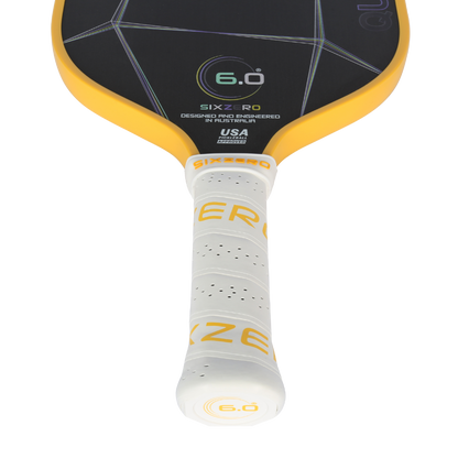 Six Zero Quartz Pickleball Paddle with yellow accents and cushioned handle, designed for quality performance and affordability