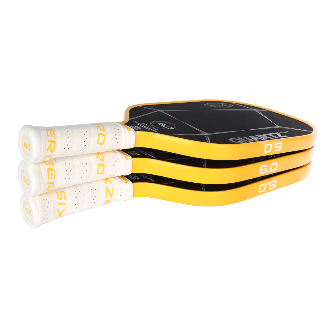 Stack of Six Zero Quartz pickleball paddles with yellow edge and white grips highlighting quality performance and affordability.