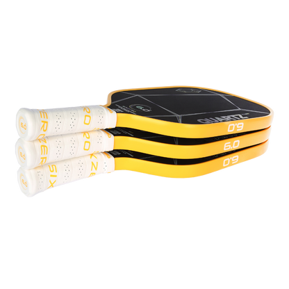 Stack of Six Zero Quartz pickleball paddles with yellow edge and white grips highlighting quality performance and affordability.