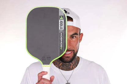 Joola Kosmos Pro V Surge Green (Global) paddle held by player showcasing new signature design.