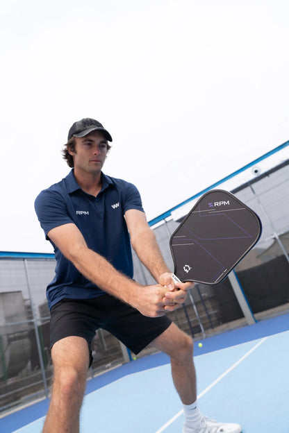 Man playing with RPM Q2 Elongated Paddle - 16MM on a court, showing performance and quality.