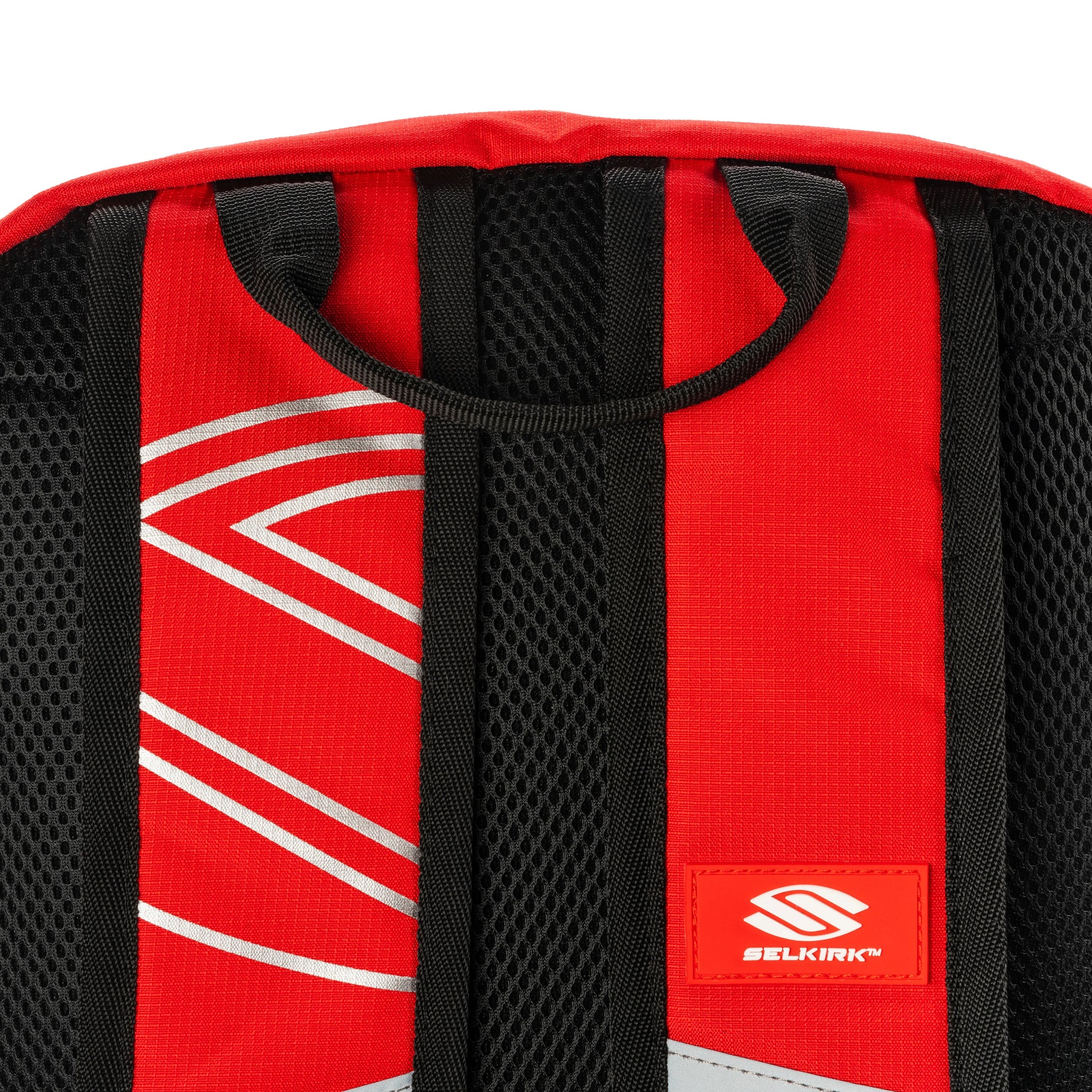 Close-up of Selkirk Core Line Day Bag's padded back panel and straps, showcasing red and black design.