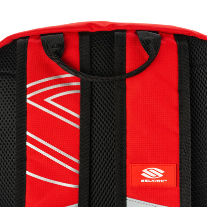 Close-up of Selkirk Core Line Day Bag's padded back panel and straps, showcasing red and black design.