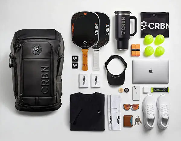 CRBN Pro Team Backpack 2.0 with accessories including paddles, balls, and apparel for pickleball players.