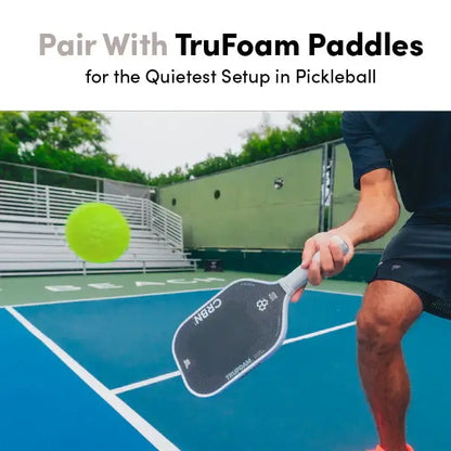 Person using CRBN Quiet Pickleballs with TruFoam paddles on a pickleball court for silent practice.