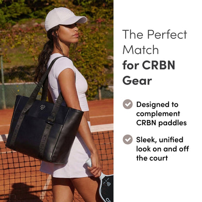 Woman holding the CRBN Club Pickleball Tote Bag [NEW] on a court, showcasing its stylish design and utility.