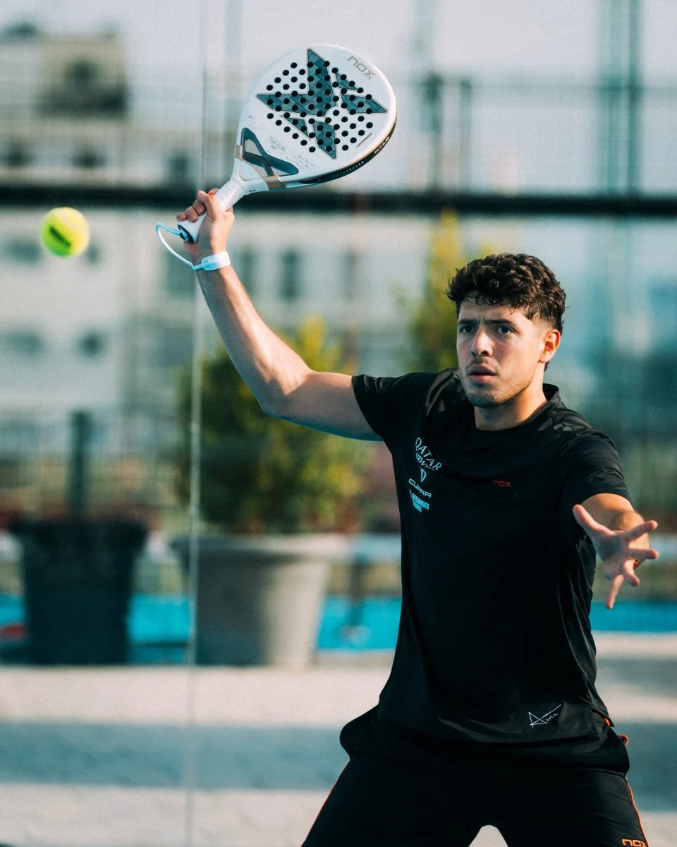 Player showcasing skills with the NOX AT10 LUXURY GENIUS 12K ALUM XTREM 2026 BY AGUSTÍN TAPIA paddle tennis racket.