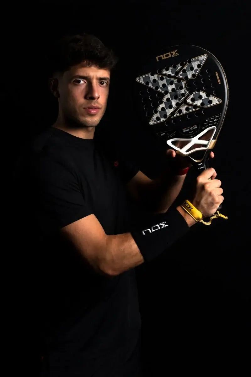 NOX AT10 LUXURY GENIUS 18K ALUM 2026 BY AGUSTÍN TAPIA, player holding the racket in a dark setting.