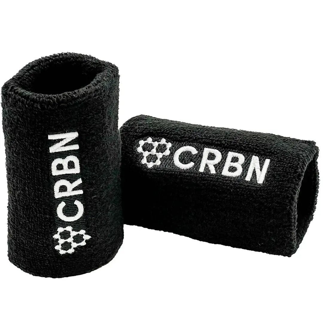 CRBN wristband set in black, featuring embroidered design, soft terry loop material, ideal for sports or style.