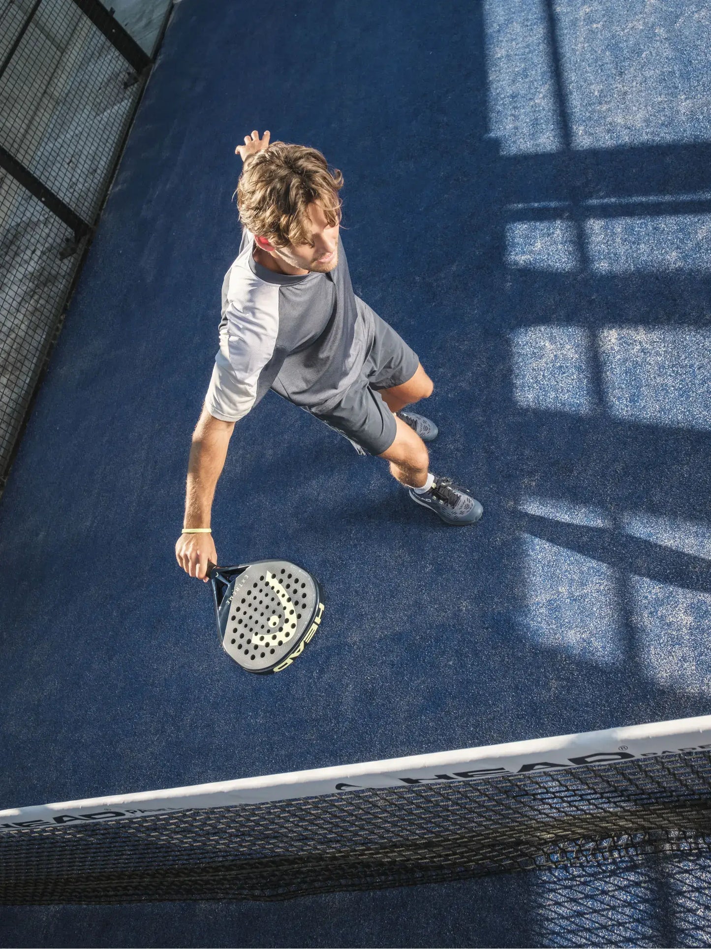 HEAD Extreme Pro Padel Racquet in use by a player on the court, showcasing powerful play.