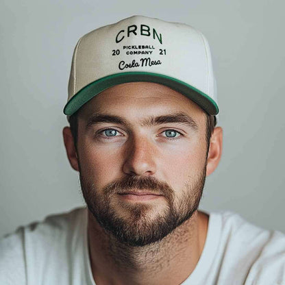 Man wearing a CRBN Heritage Snapback hat with classic pickleball design and vintage charm.