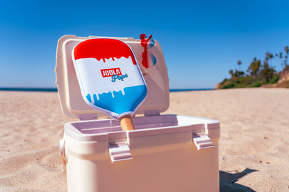 Joola Perseus Pro V Rally Rocket (Limited Edition) resting on a beach cooler on a sunny day.