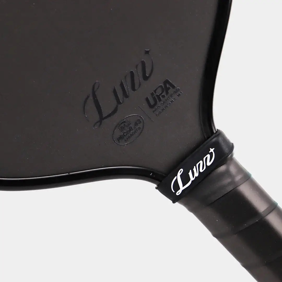 Luzz Cannon2 M1 Paddle showcasing the sleek design and UPA certification marking for competitive play.