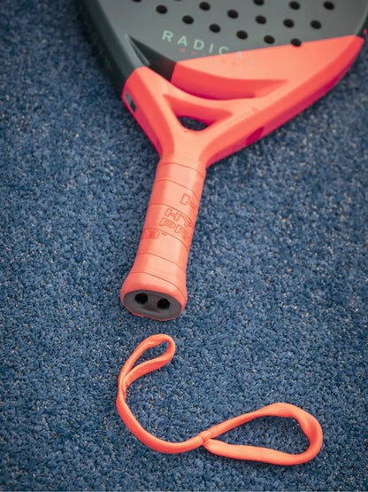 HEAD Radical Motion Padel Racquet grip and wrist strap on blue court surface.
