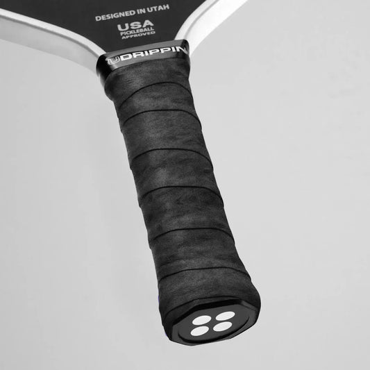 Close-up of Udrippin Pro Dry Grip on a pickleball paddle, showcasing premium wet absorbing material and comfort.