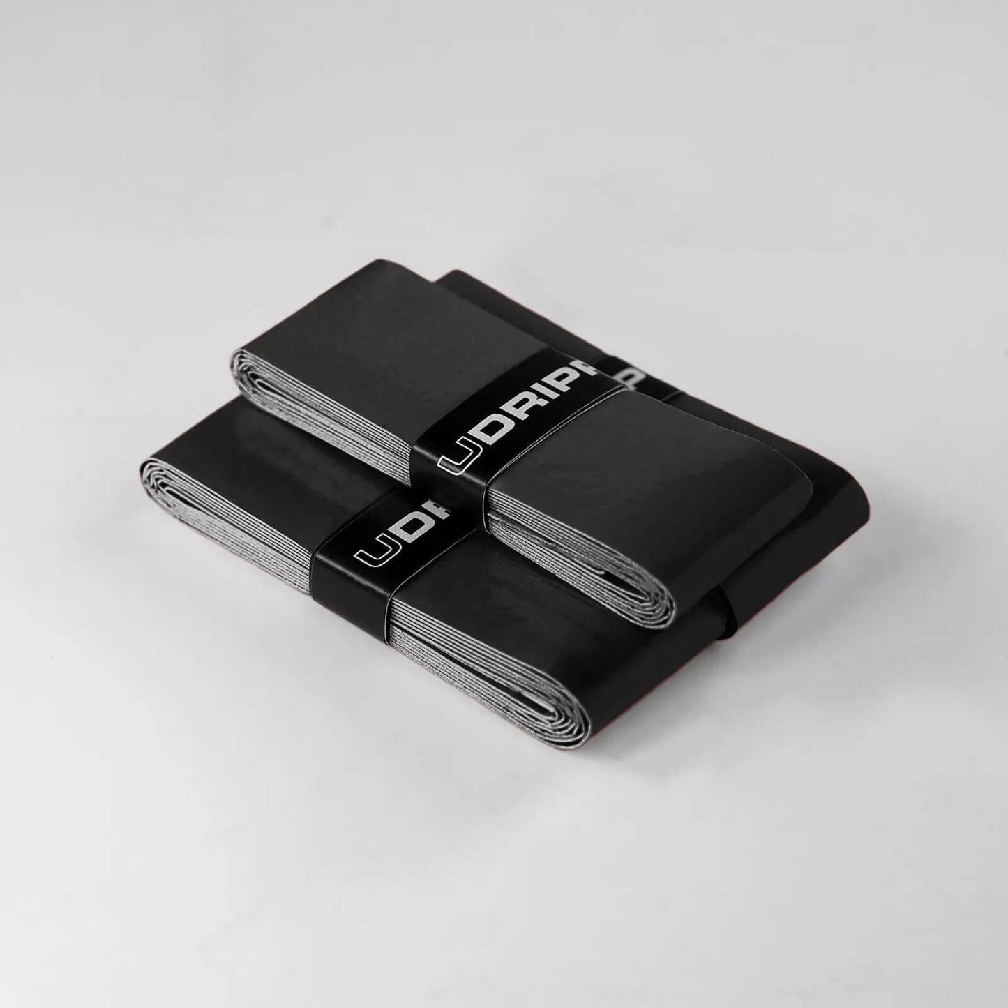 Udrippin Pitch Black - Pro Tour grip packs stacked together showcasing high quality tack and design.