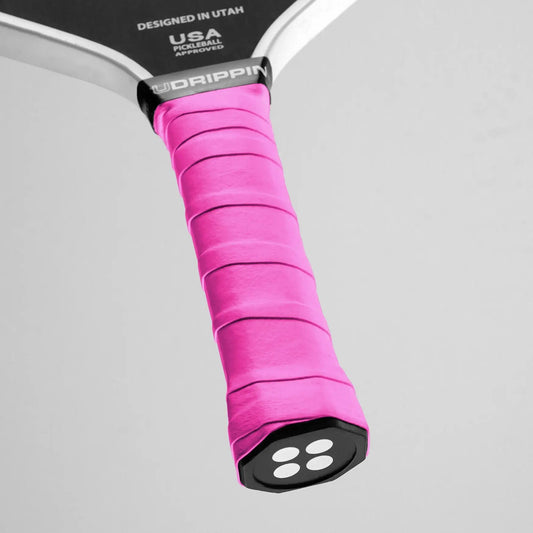 UDRIPPIN Comfort Tour Grip in pink on pickleball paddle with high-quality tack and sweat absorbent features for improved comfort and longer-lasting grip.