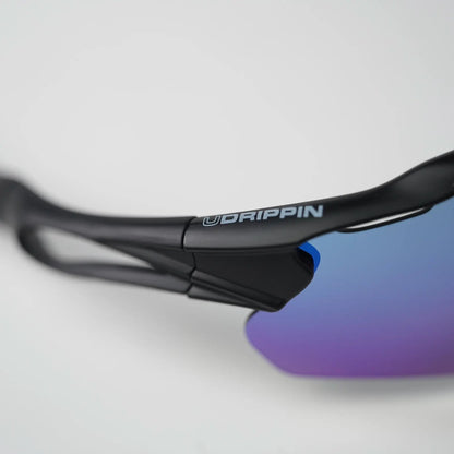 UDRIPPIN NIZO sunglasses with blue-green high contrast lens, close-up side view showing sleek black frame and lens detail.