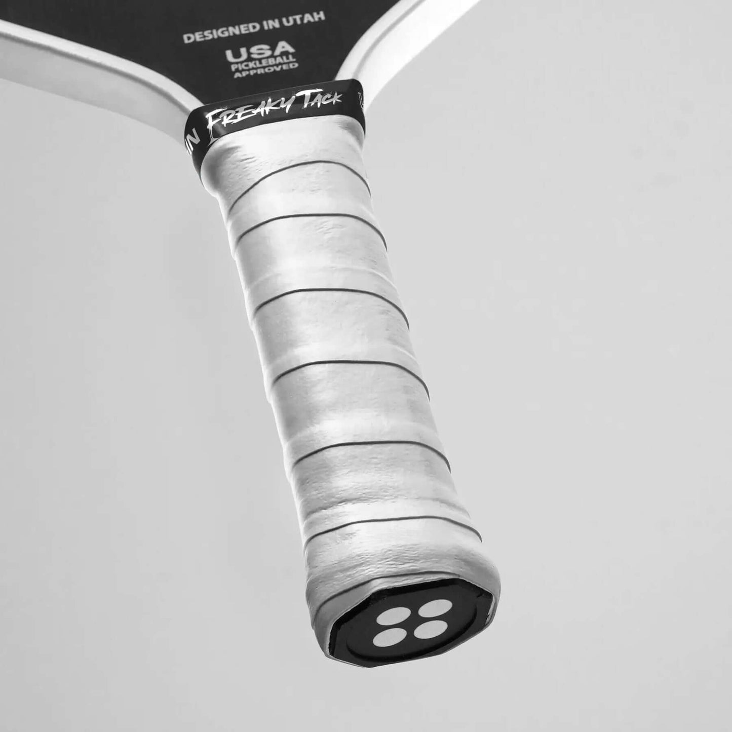 Close-up of the Udrippin FREAKY TACK Grips on a paddle, showcasing its unique, ultra-tacky texture for optimal control.